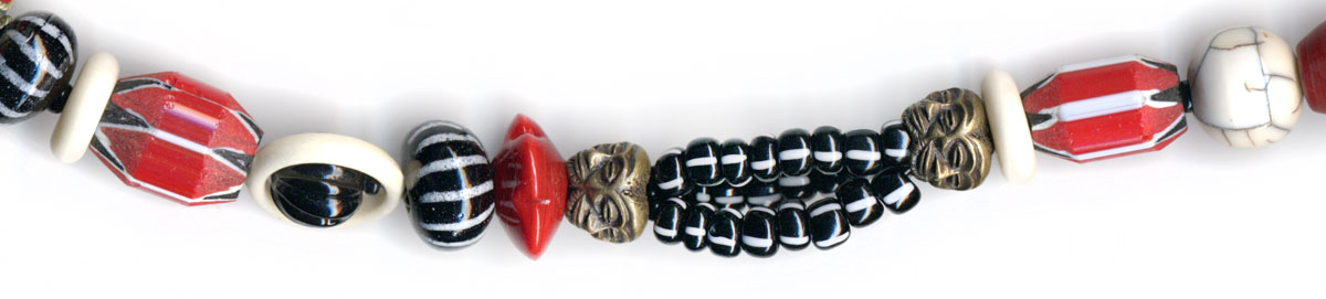Zanzibar, an asymetrical necklace in glass, coral & bone with trade beads, ceramics & brass from Africa