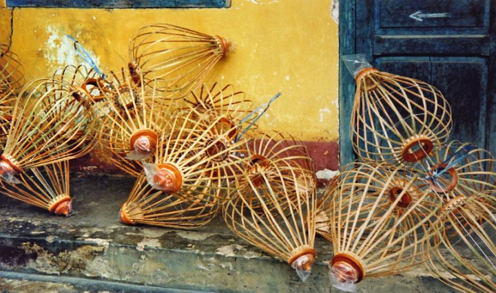 lantern 'skeletons' against a yellow wall in Hoi An, Vietnam